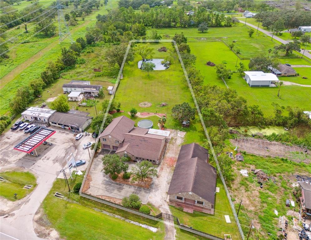 an aerial view of a house with a garden and swimming pool