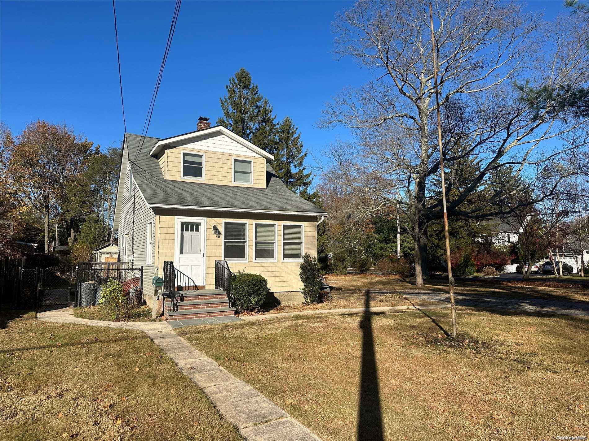 a front view of a house with a yard covered with snow