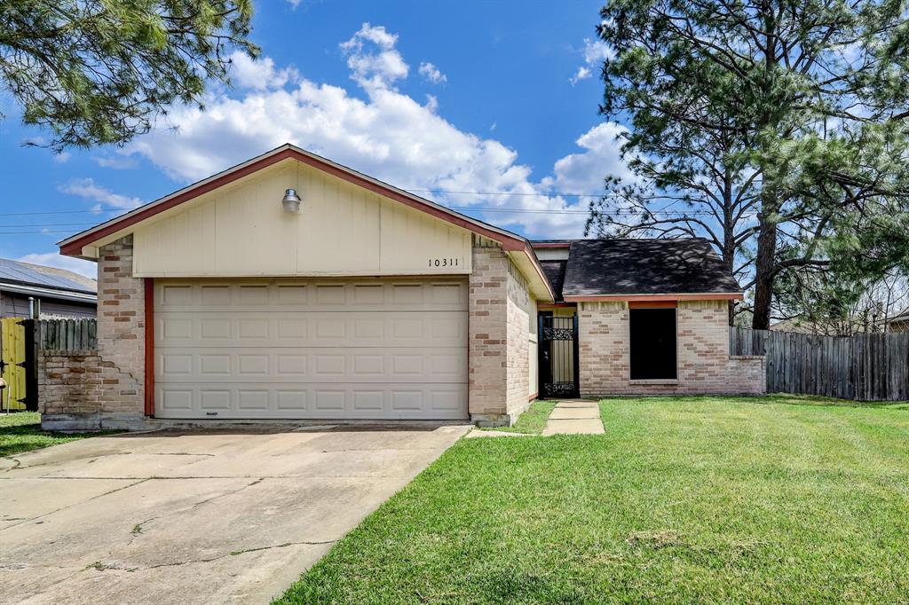 a view of a house with a yard and garage