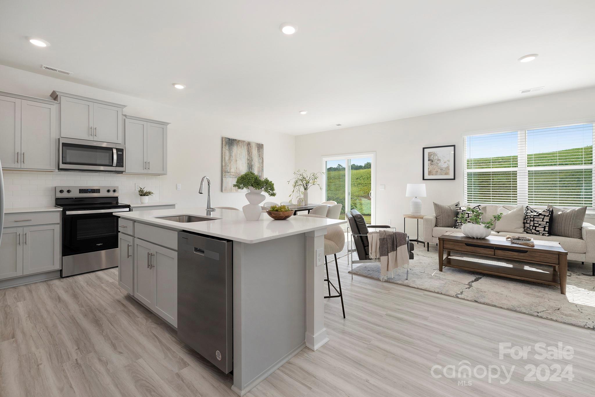 a kitchen with counter top space cabinets and appliances