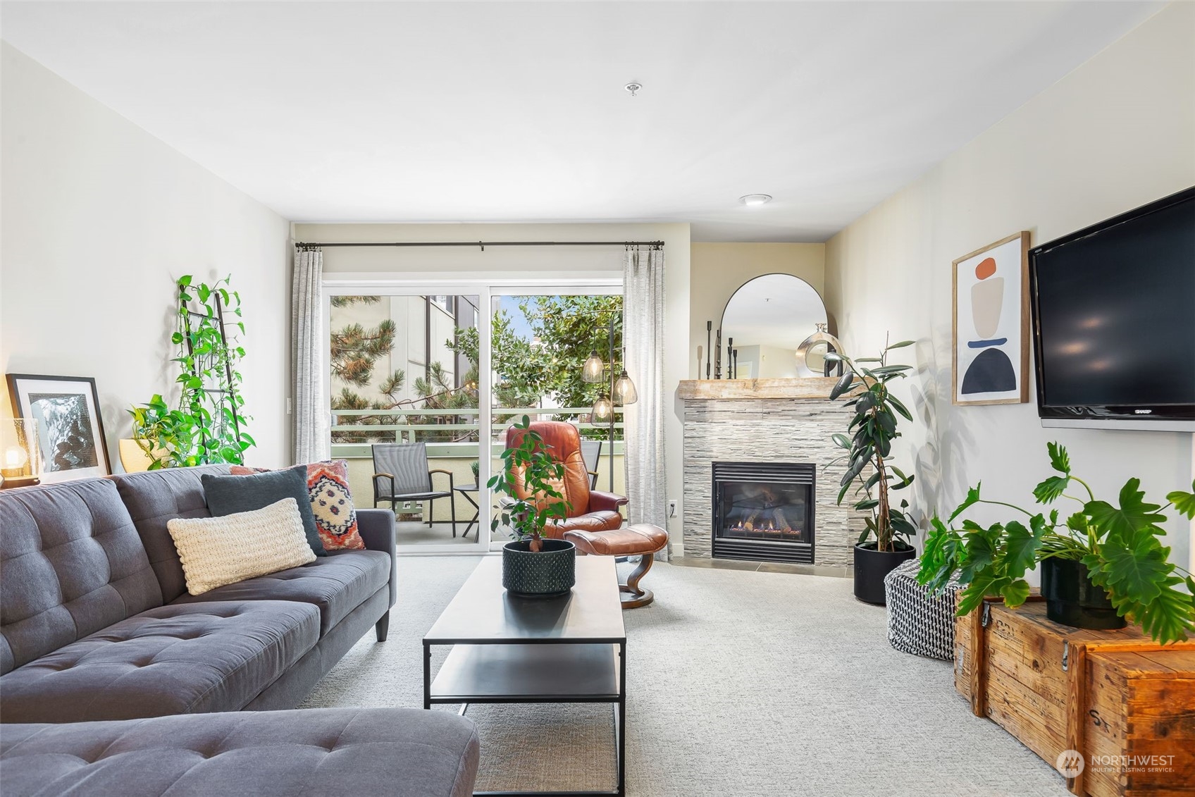 a living room with furniture a fireplace and a flat screen tv