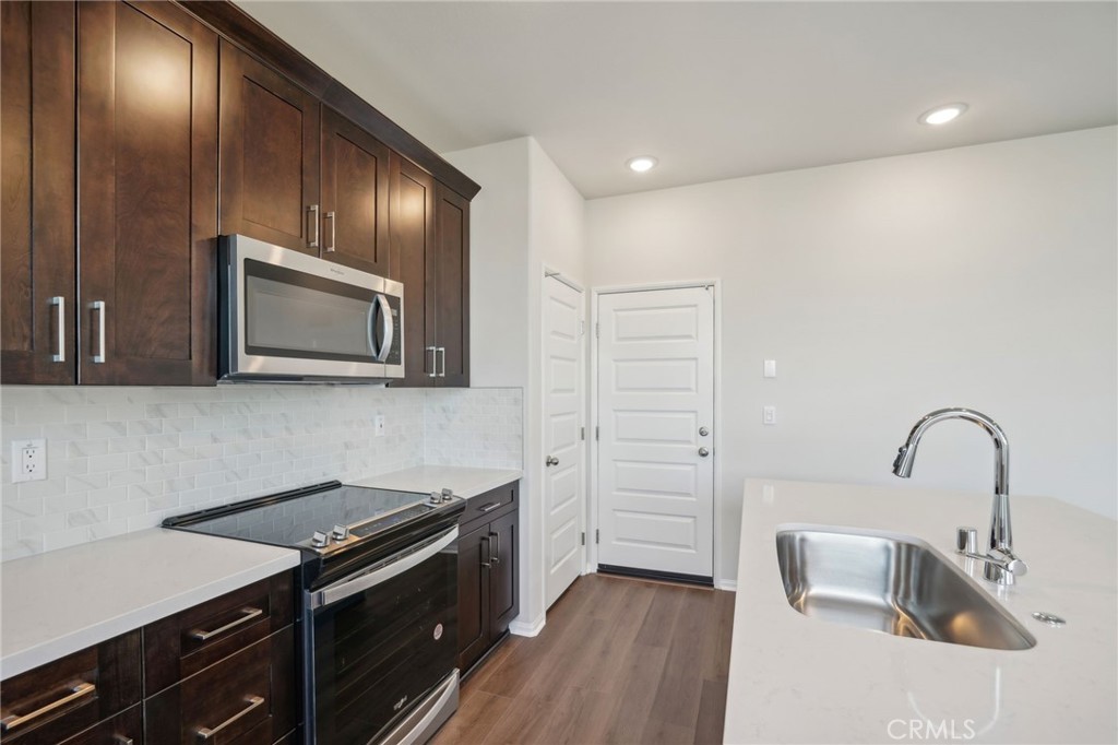 a kitchen with sink cabinets and stainless steel appliances