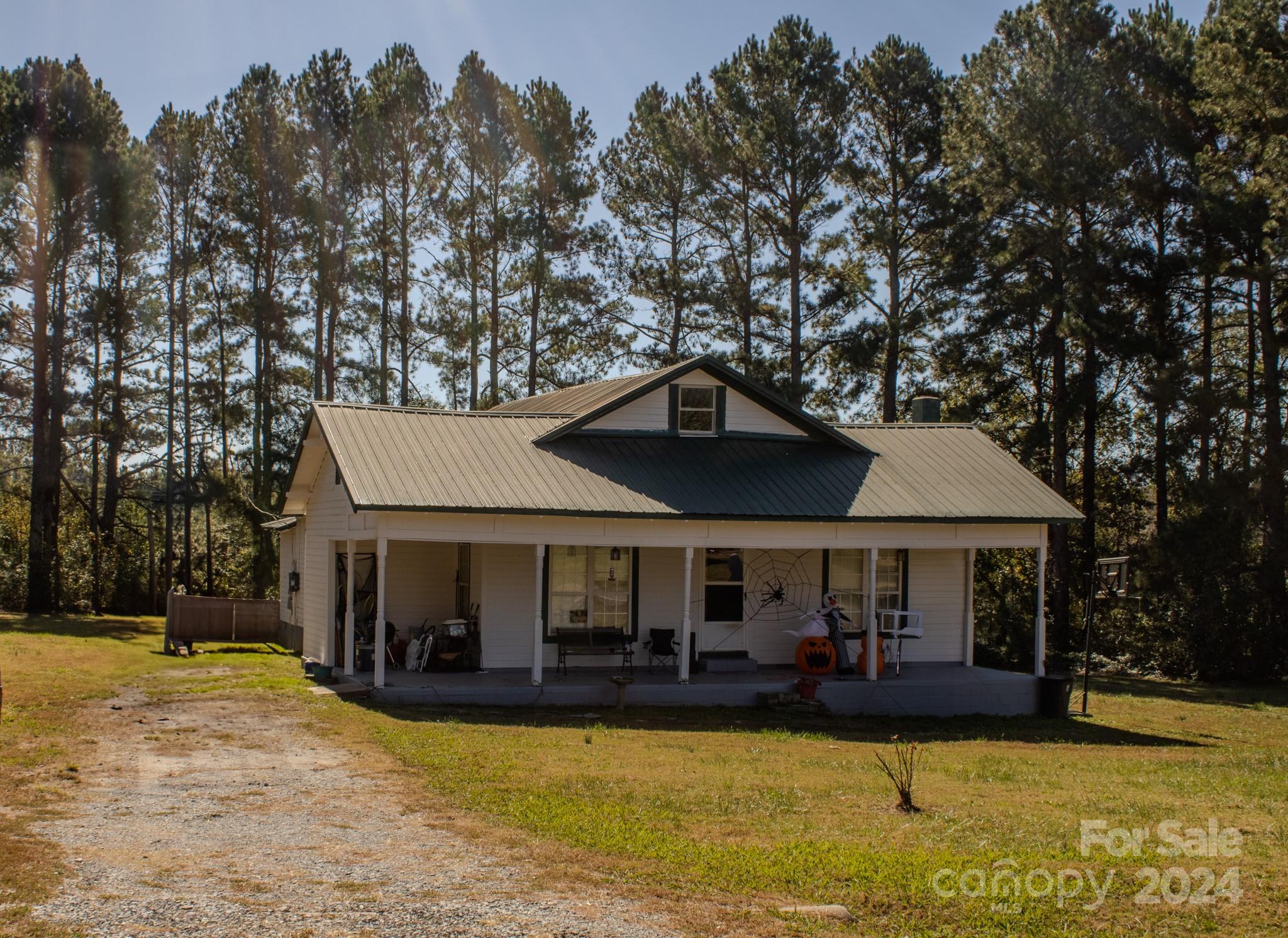 a front view of a house with yard porch and furniture