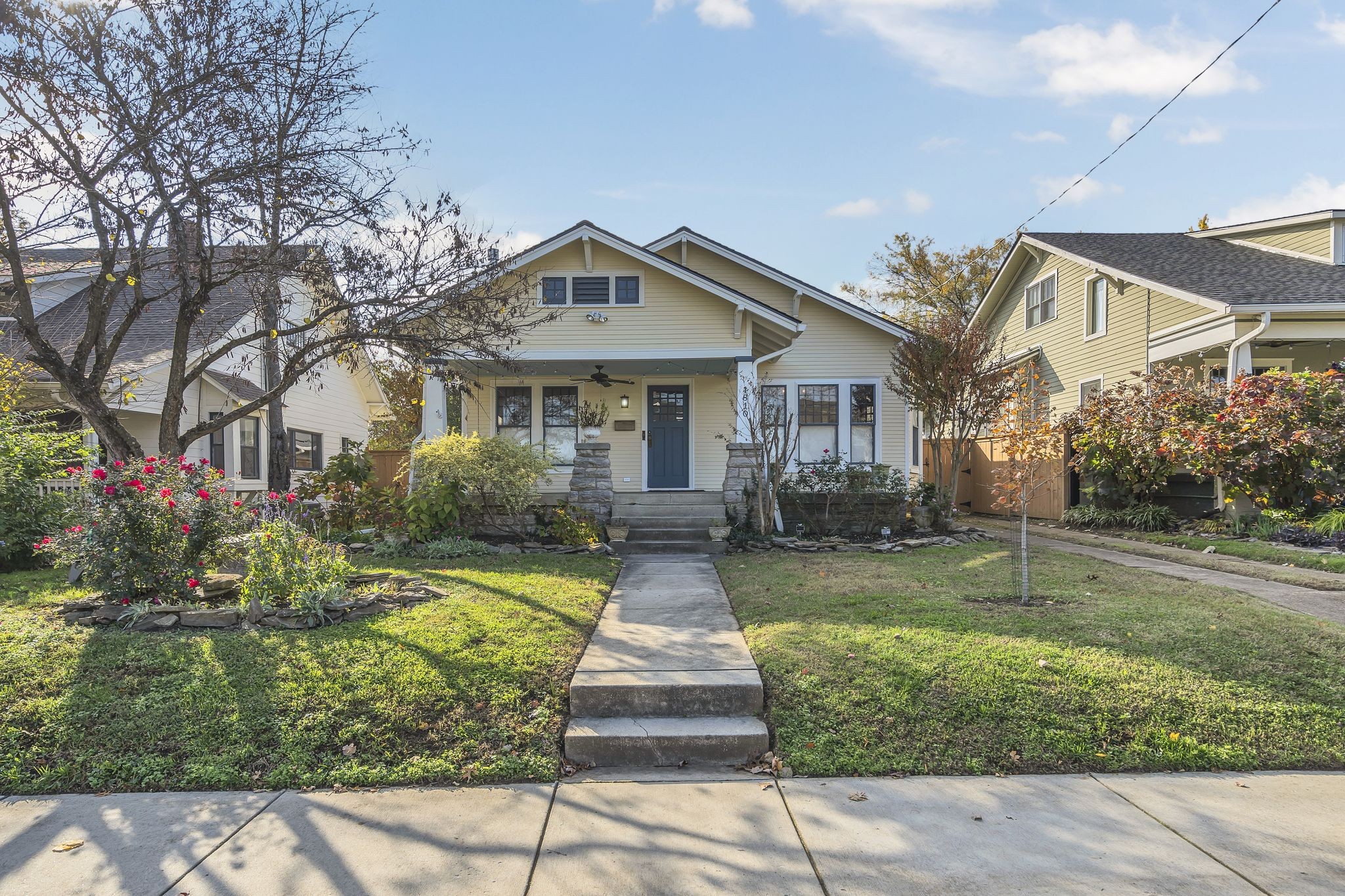 a front view of a house with a yard and garden