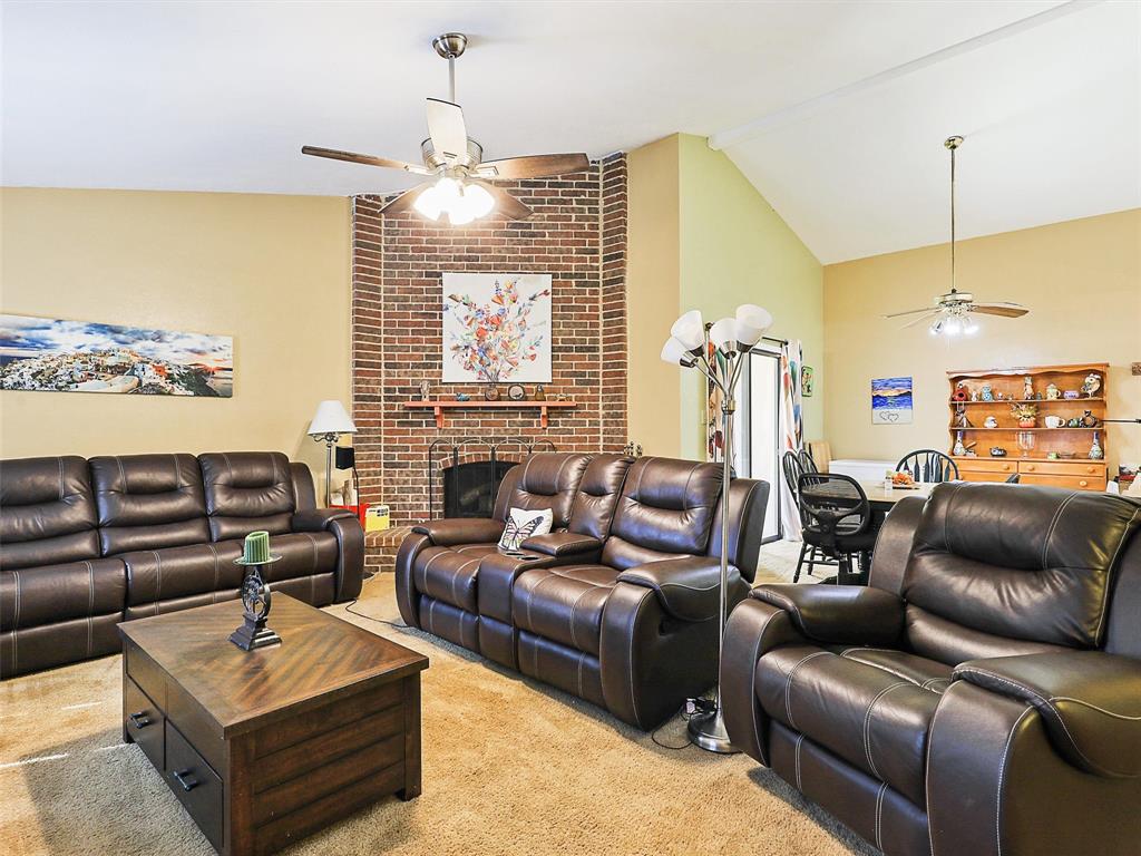 a living room with furniture a ceiling fan and a window