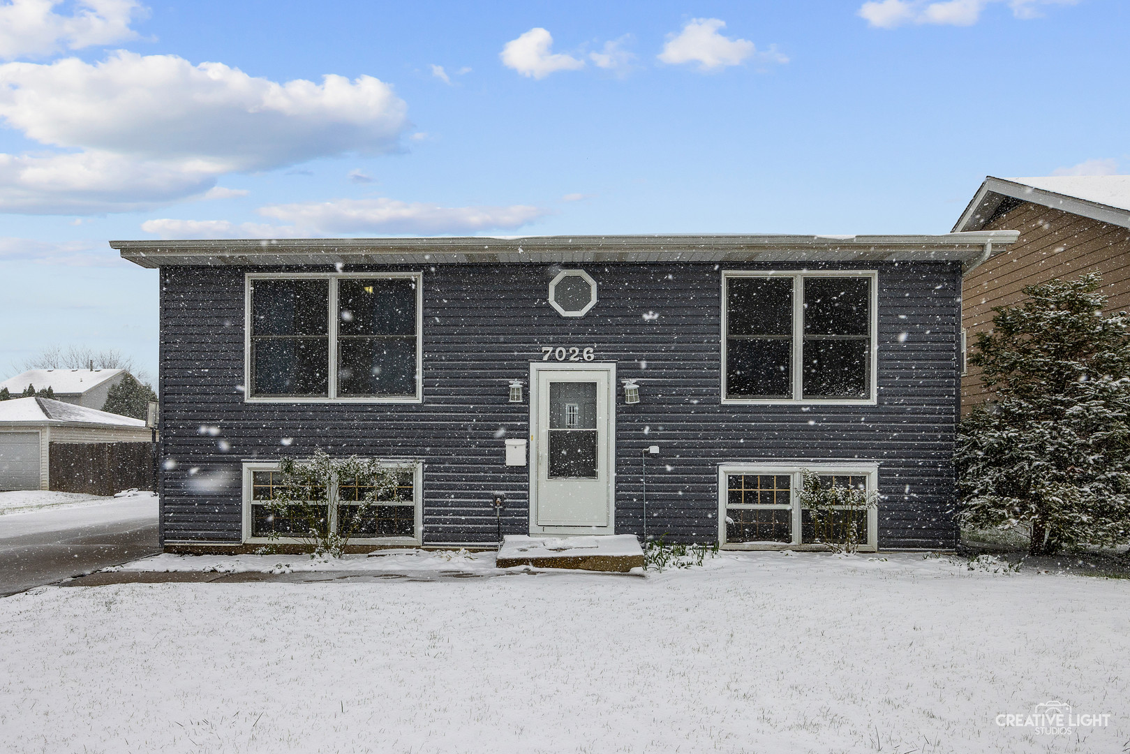 a front view of a house with garage