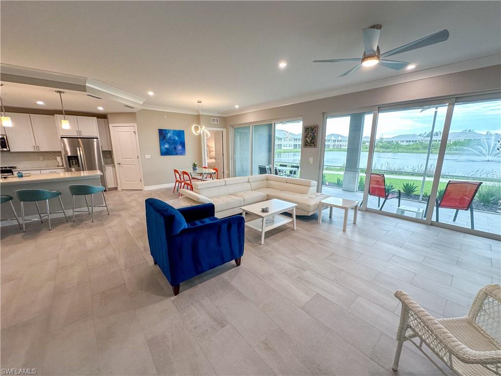 a living room with furniture and a floor to ceiling window