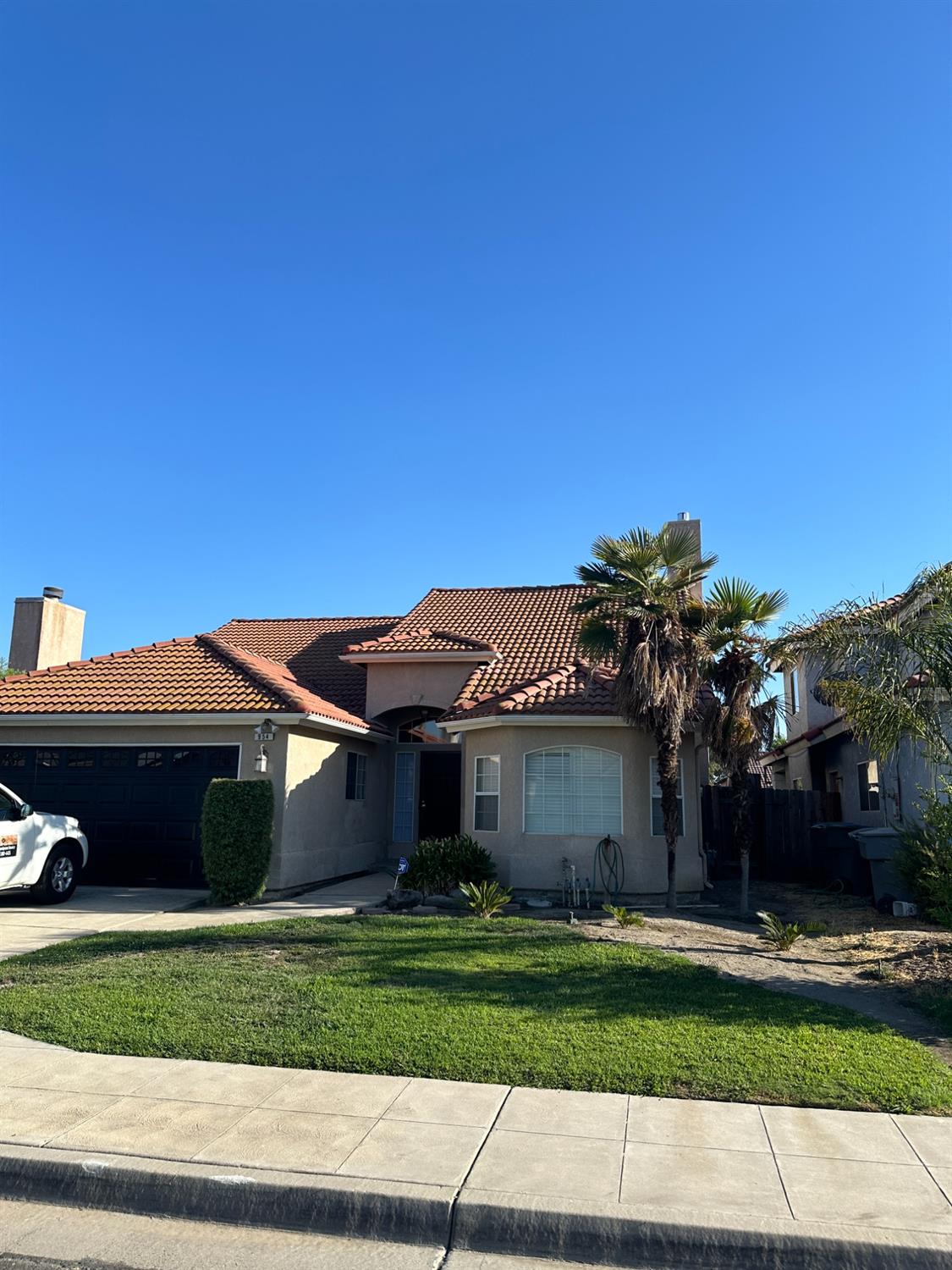 a front view of a house with a yard and a garage