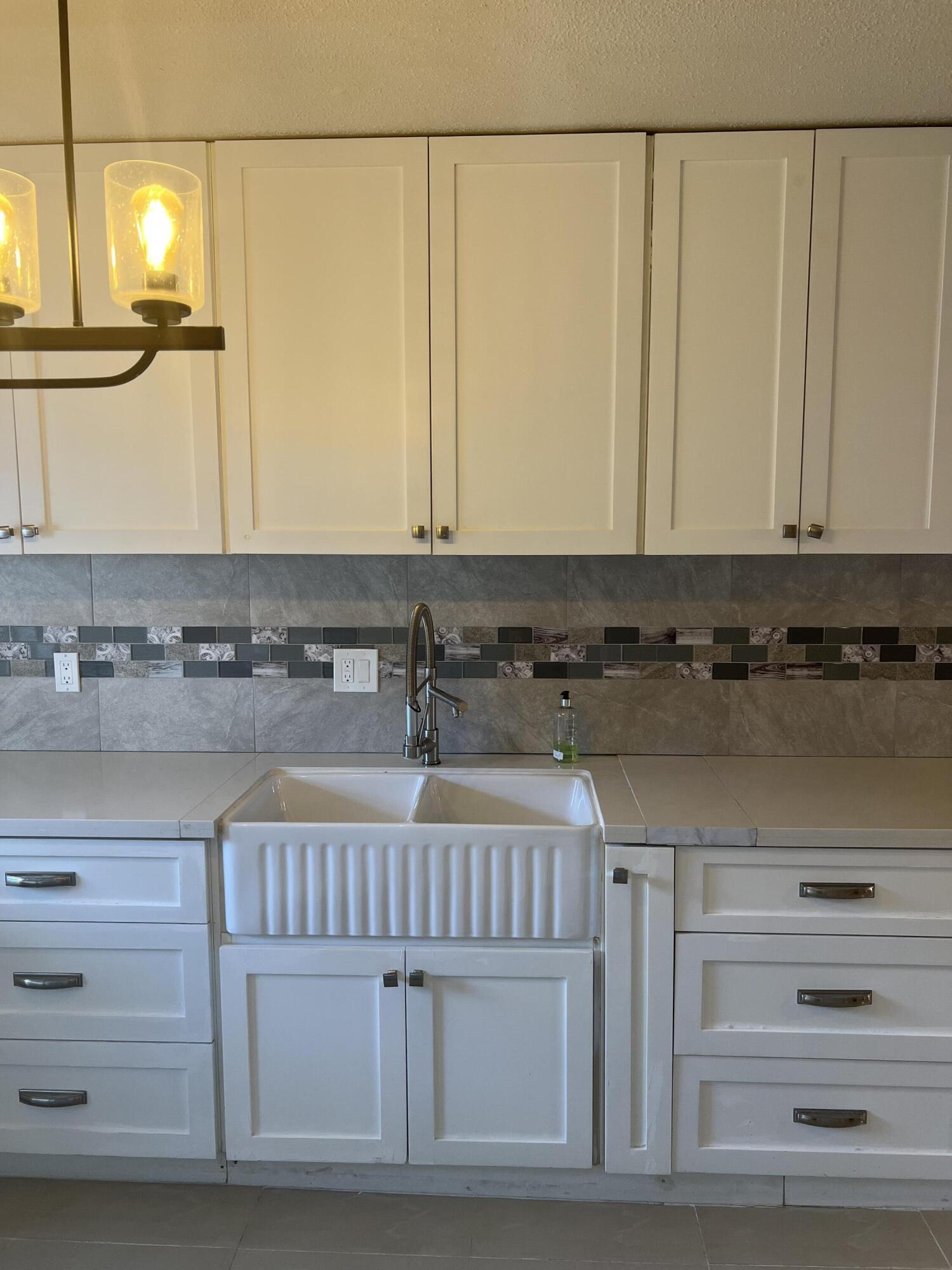 a view of kitchen with stainless steel appliances granite countertop cabinets and a counter top