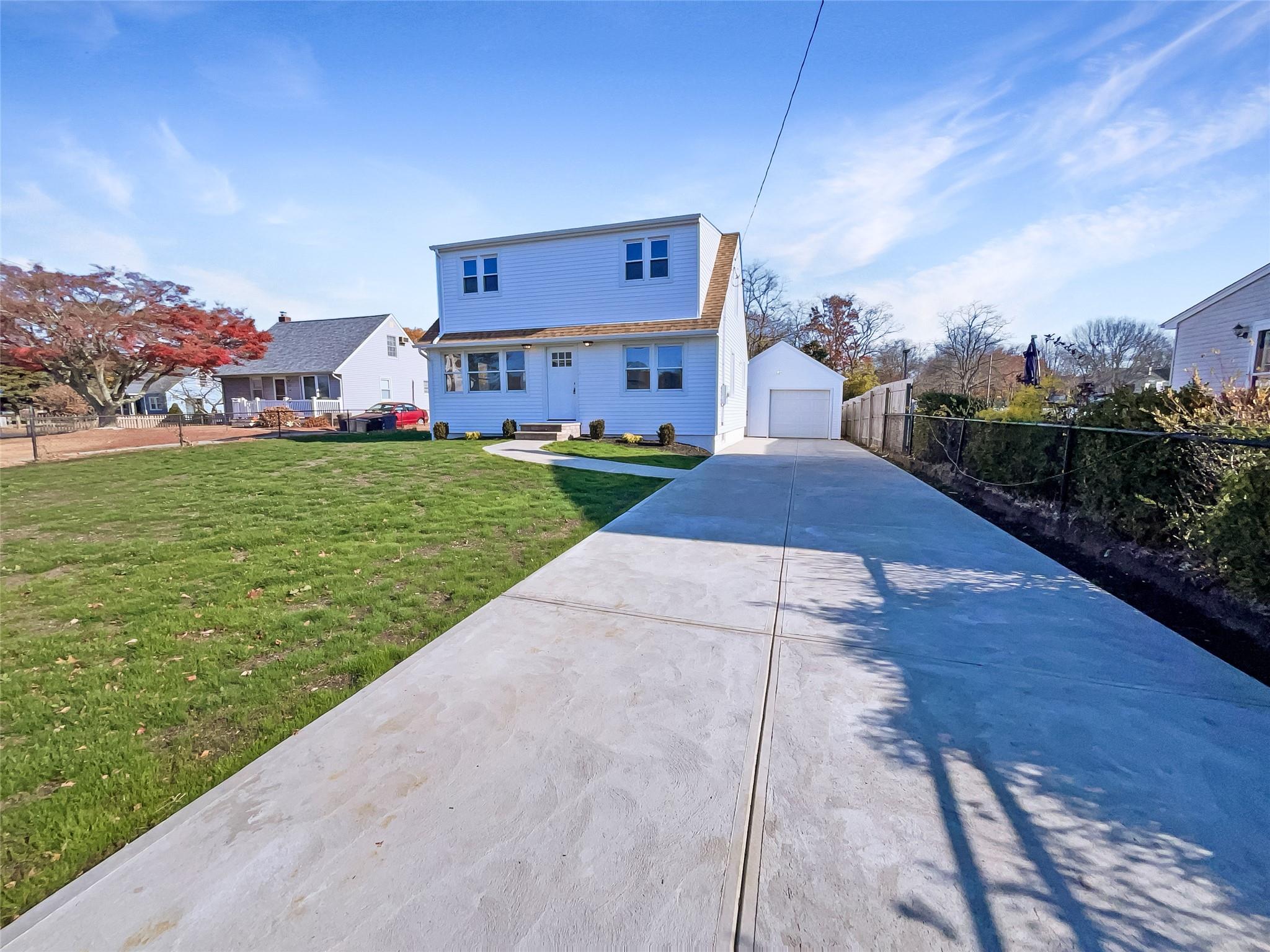 a view of a house with a yard and pathway