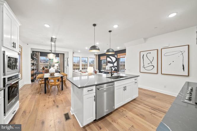 a kitchen with stainless steel appliances granite countertop a stove and cabinets