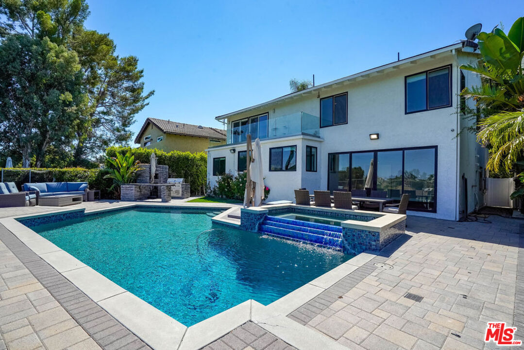 a view of a house with swimming pool and sitting area