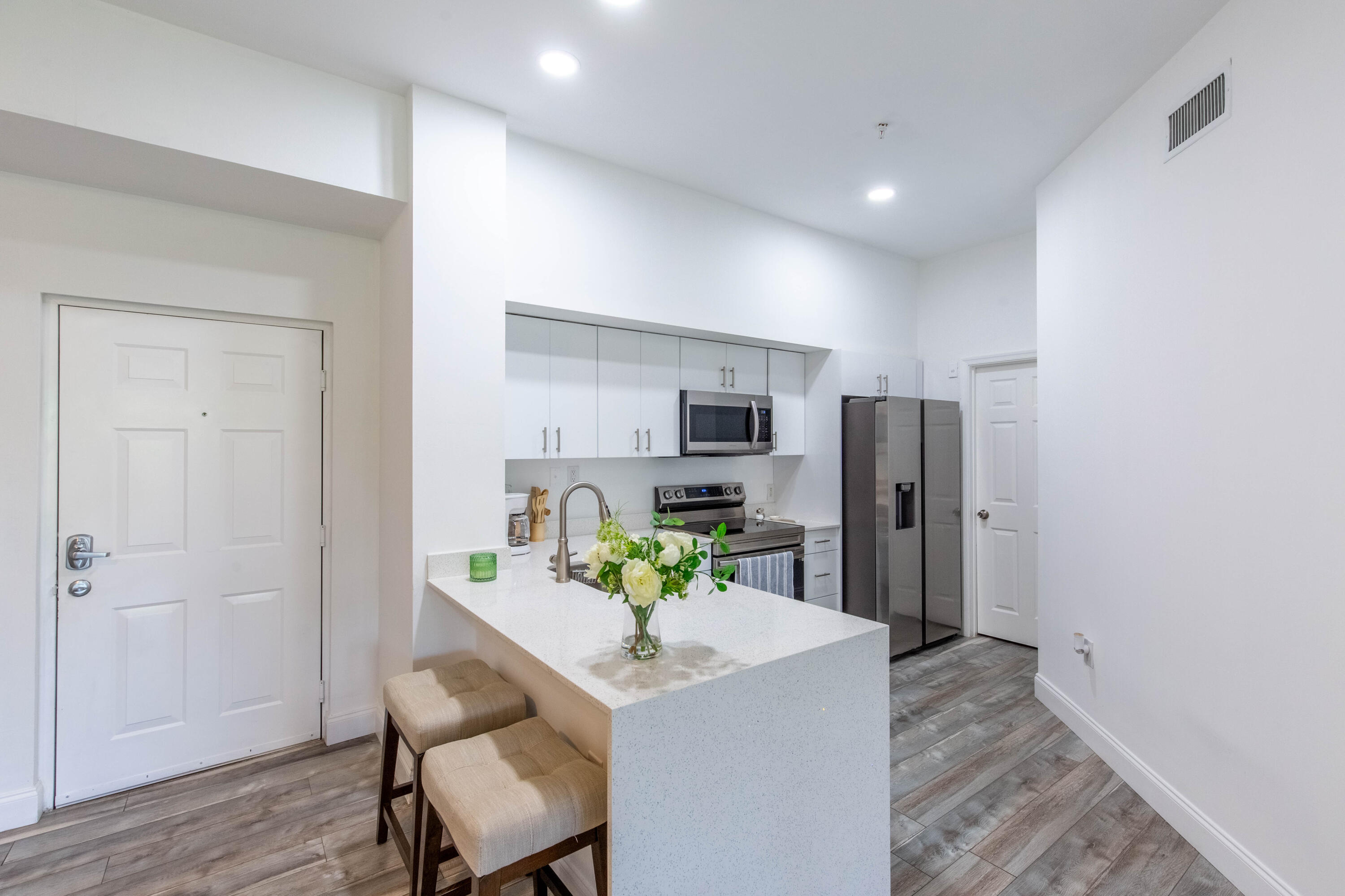 a kitchen with stainless steel appliances granite countertop a refrigerator and a stove top oven