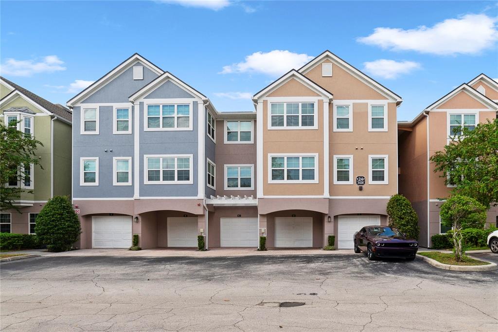 a front view of a house with a yard and parking space