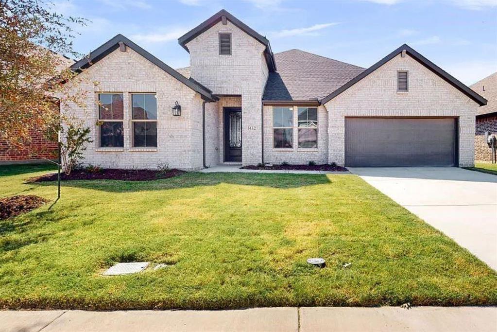 a view of a house with a yard and garage