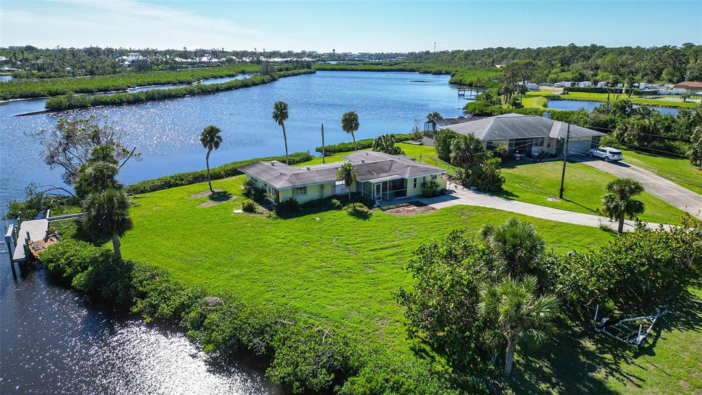 an aerial view of a house with outdoor space and lake view