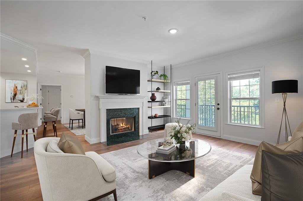 a living room with furniture a fireplace and a flat screen tv