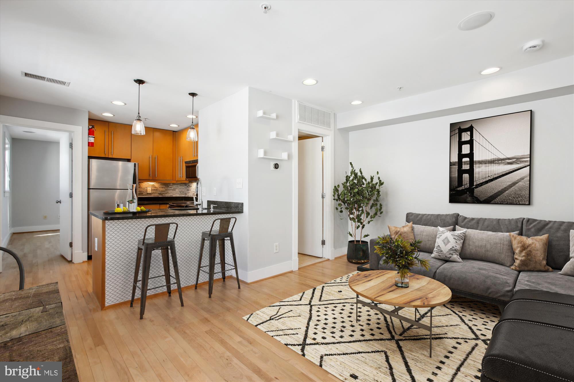 a living room with furniture and kitchen view