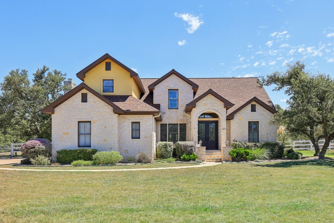 a front view of a house with garden