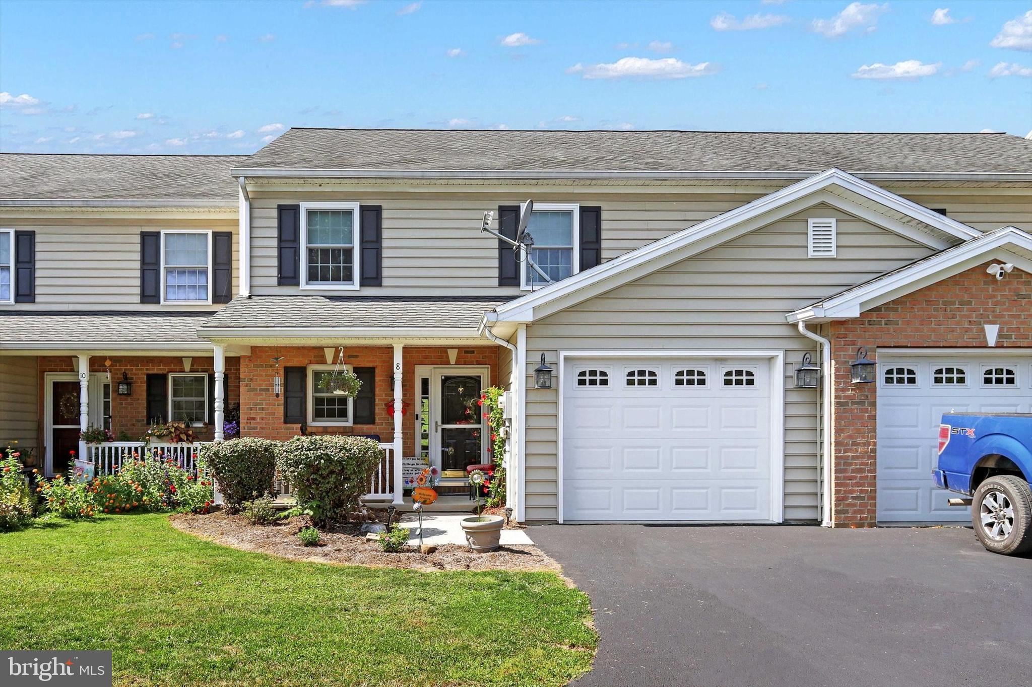 a view of a house with a yard and garage