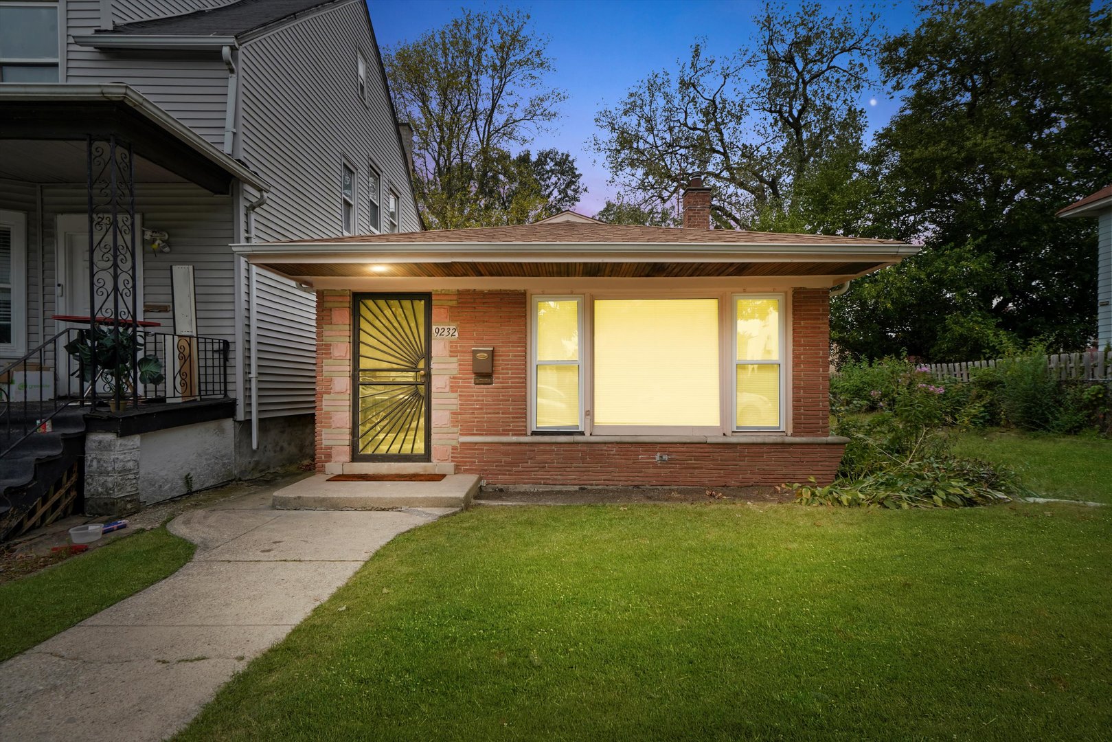 a front view of a house with a garden