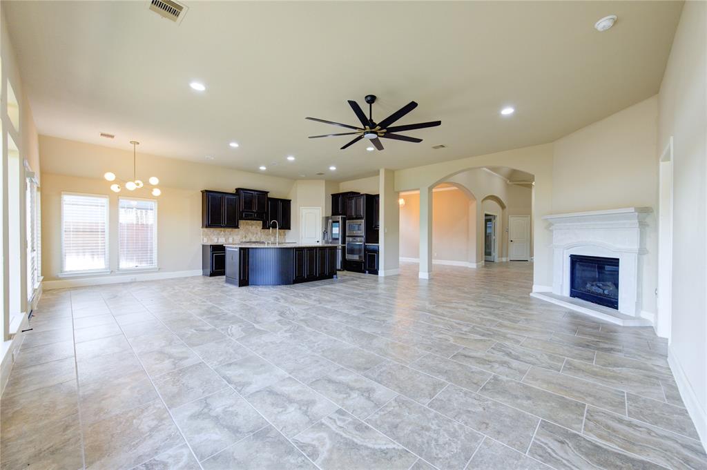 a view of a kitchen with a sink and a fireplace