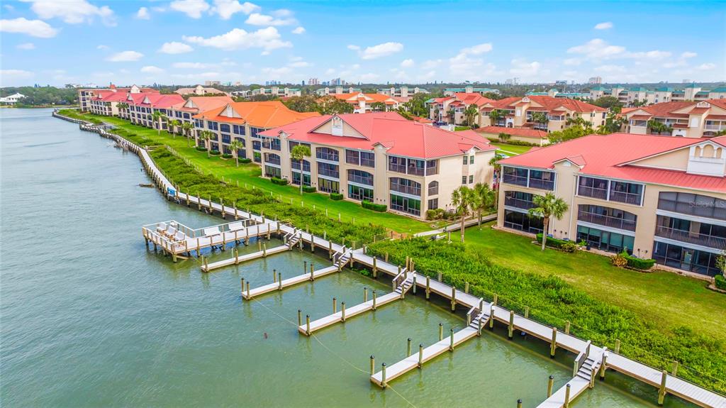 an aerial view of a house with a garden and lake view