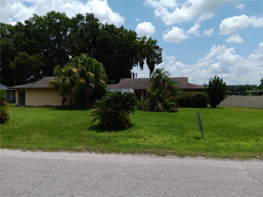 a view of a house with a yard and a garden