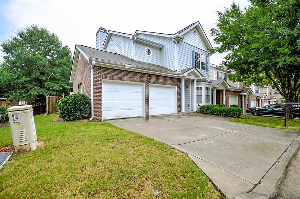 a front view of a house with a yard and garage