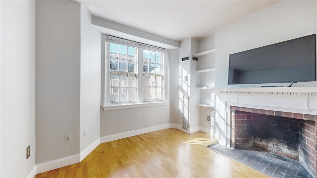 a bedroom with a bed and a fireplace