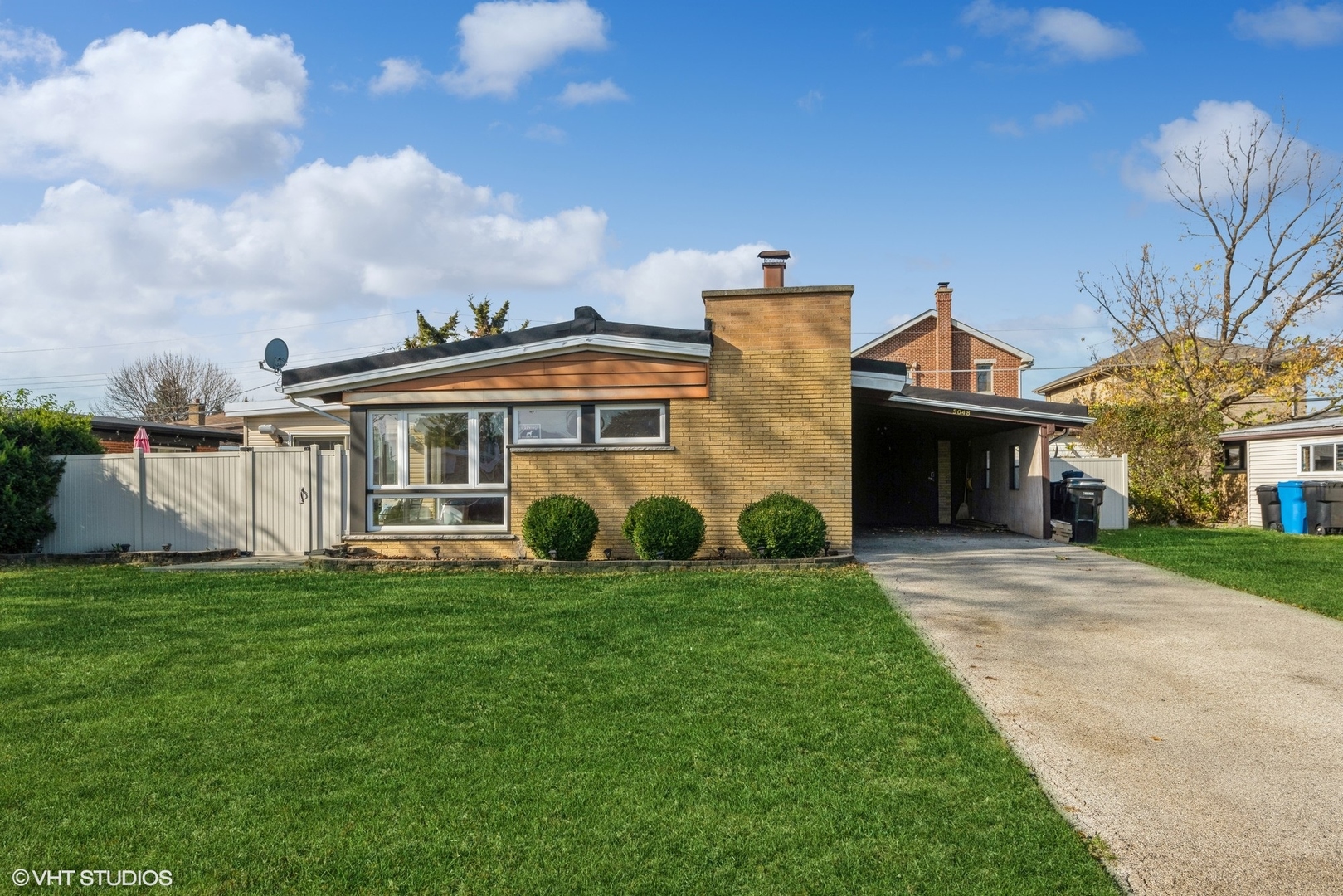 a view of a house with a yard and sitting area