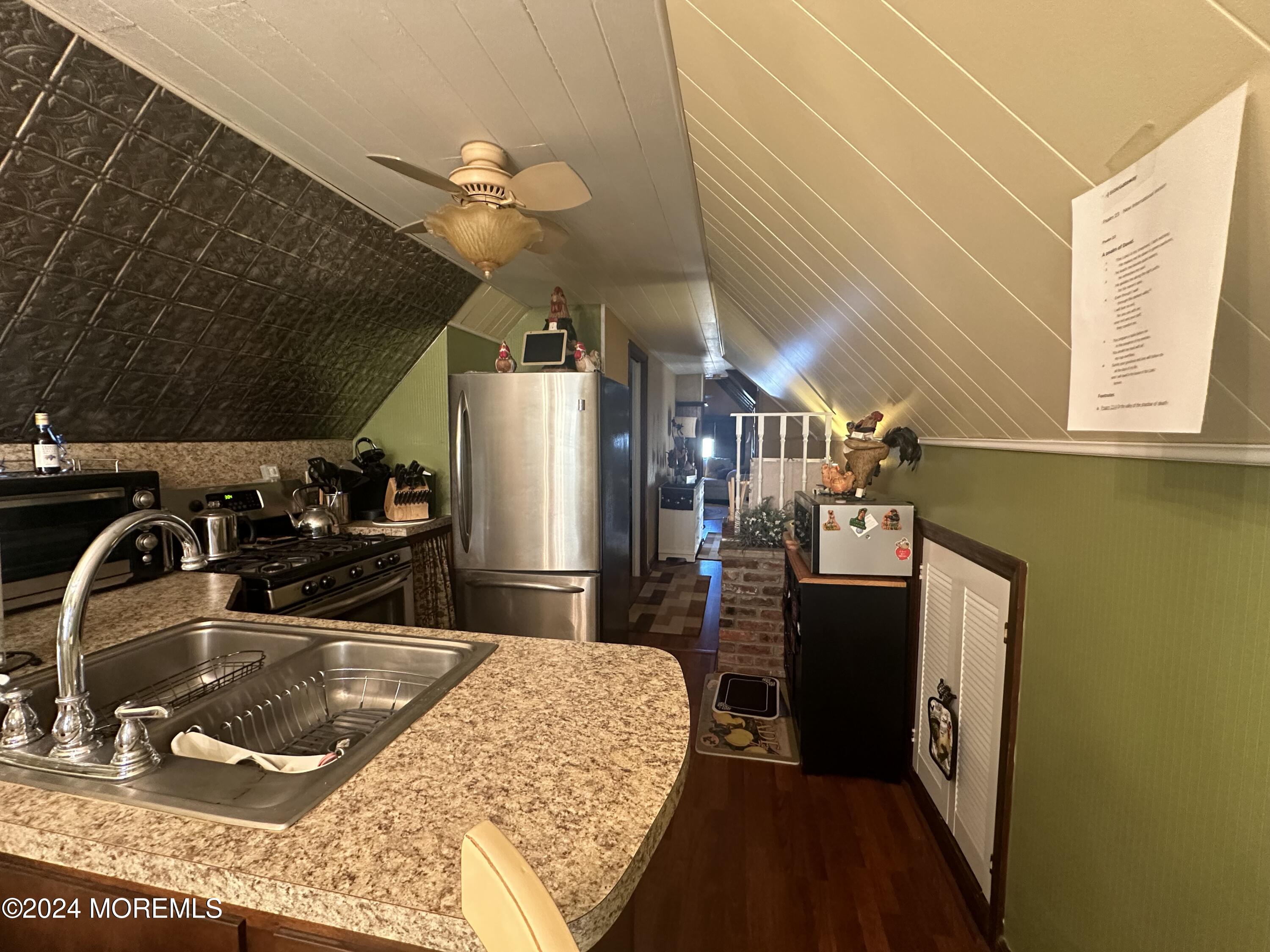 a kitchen with a sink a refrigerator and a stove