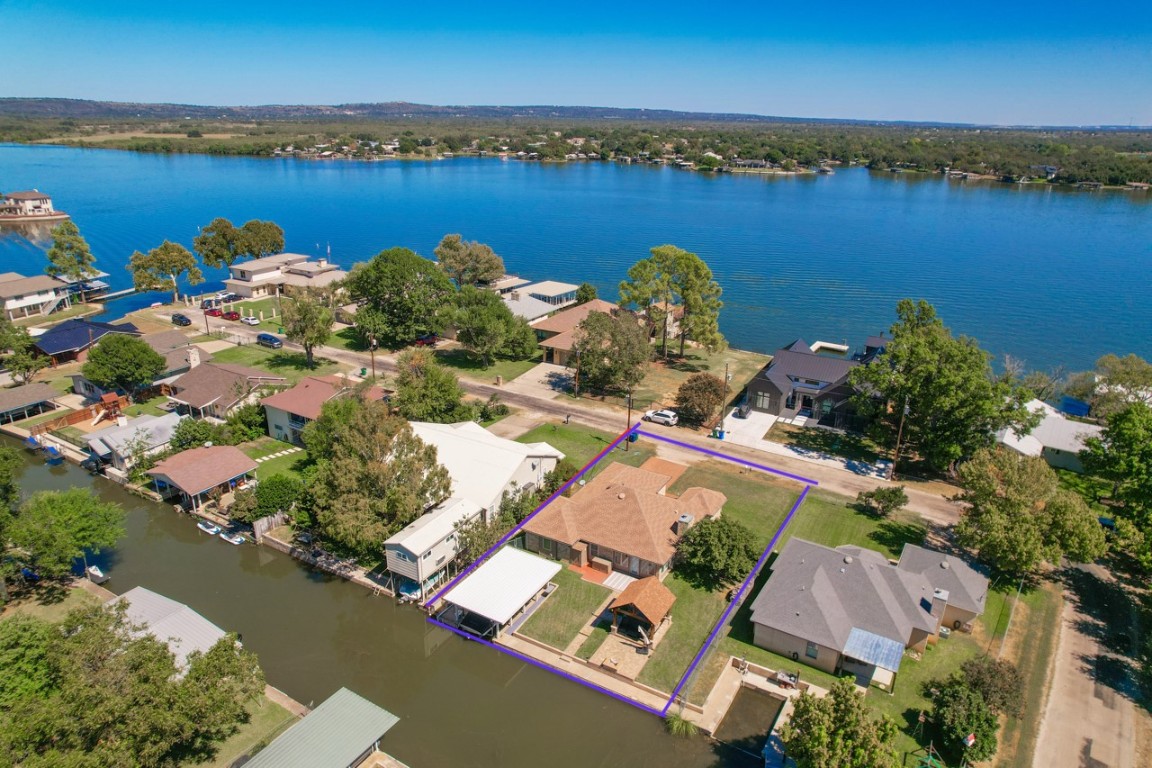 an aerial view of a house with a lake view