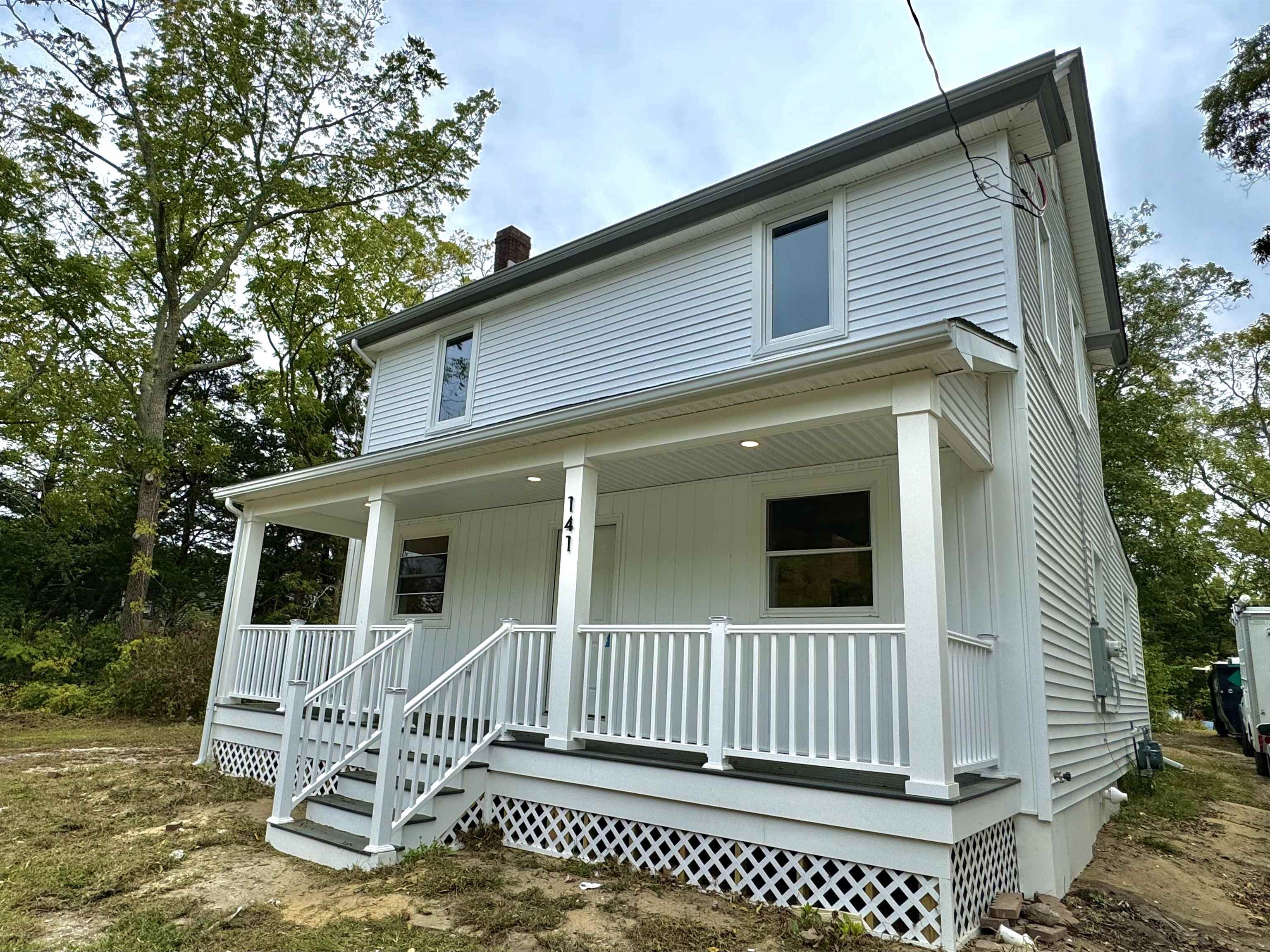 a view of a house with a window and wooden fence