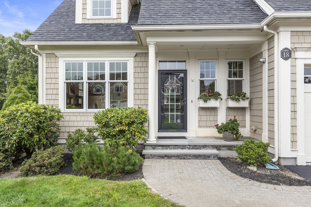 front view of a brick house with a yard