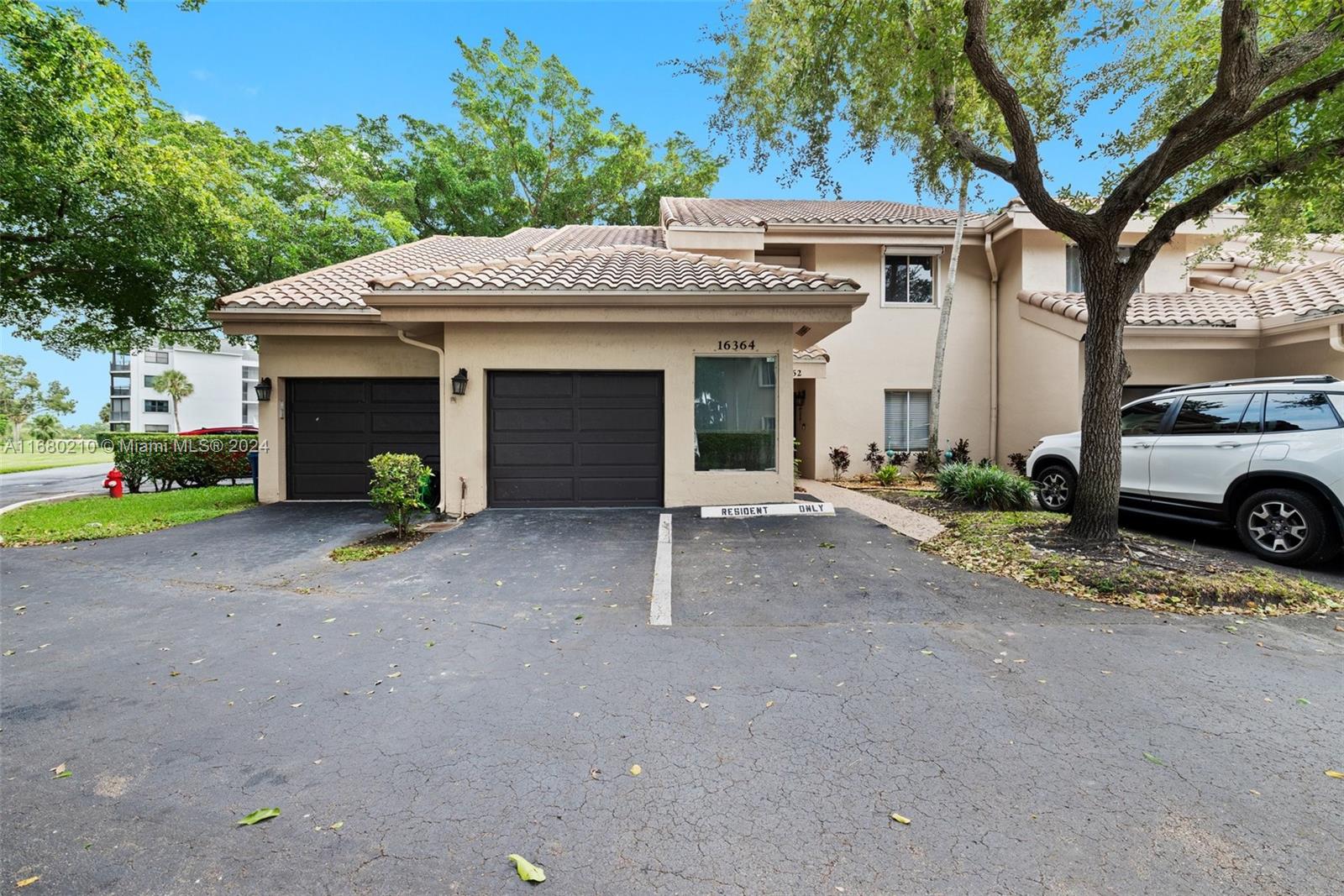 a view of a house with a yard and garage