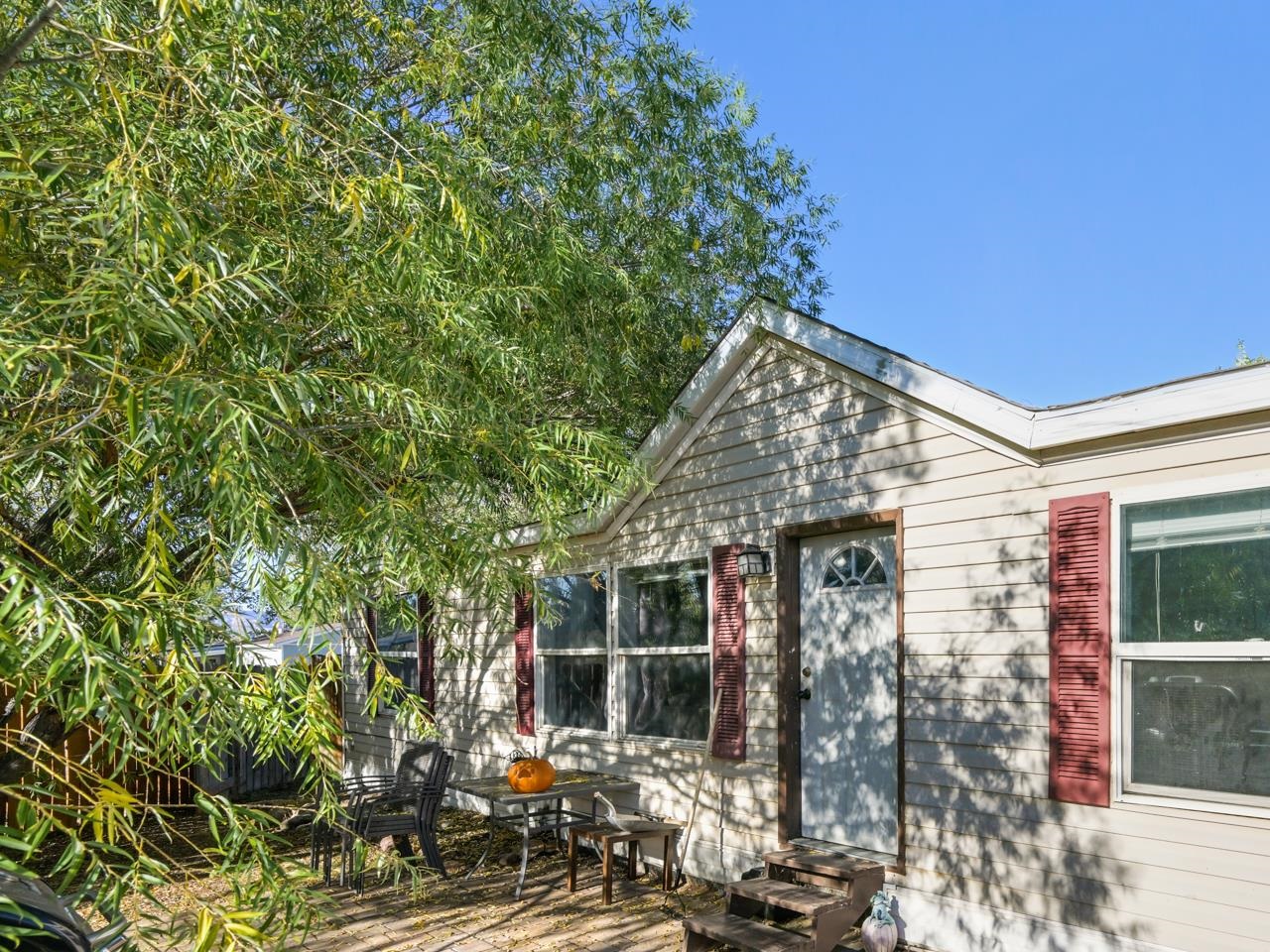 a view of a house with yard and sitting area