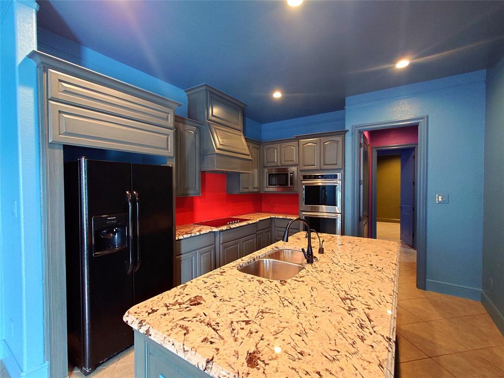 a kitchen view with stainless steel appliances kitchen island a refrigerator sink and stove