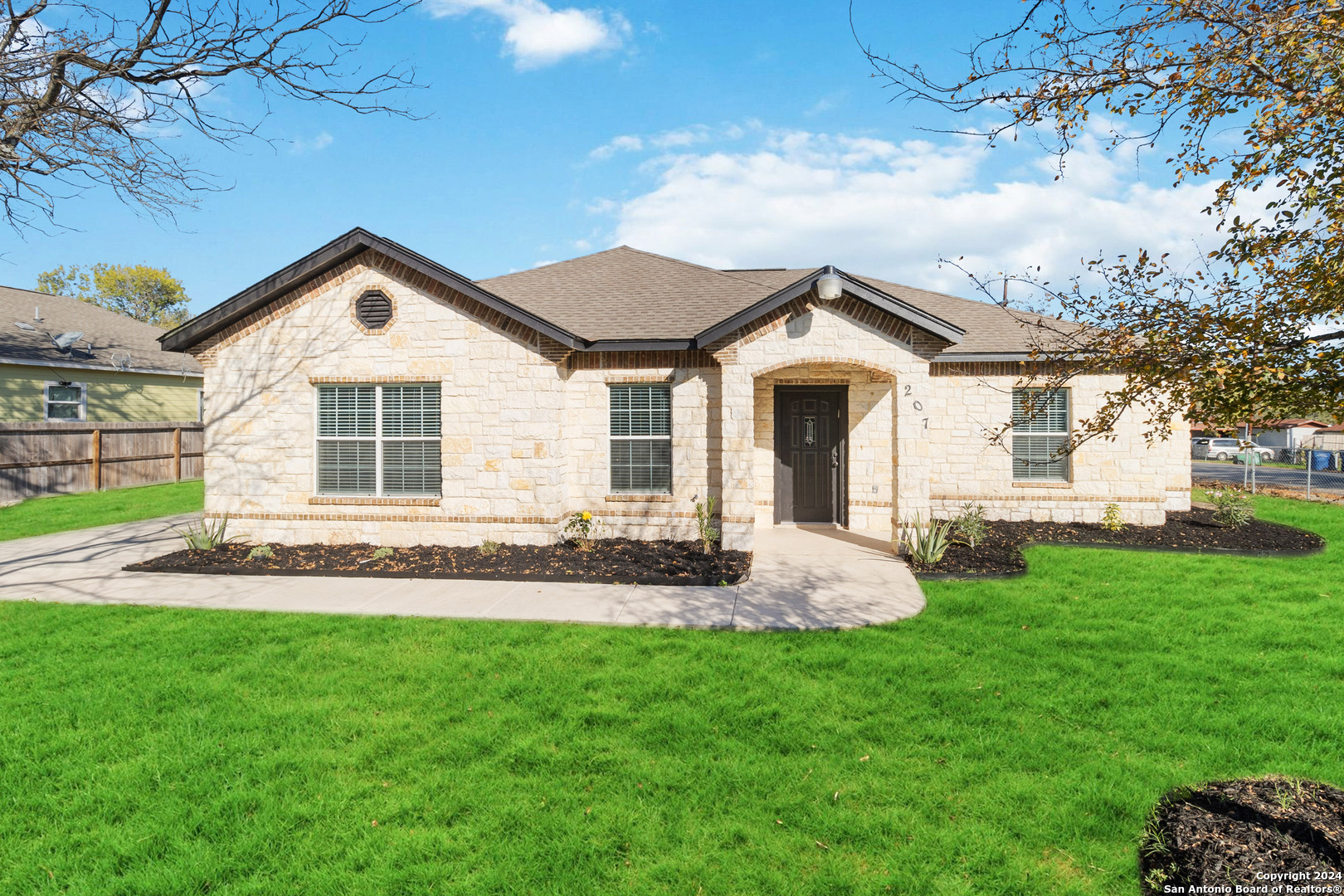 a front view of a house with a yard