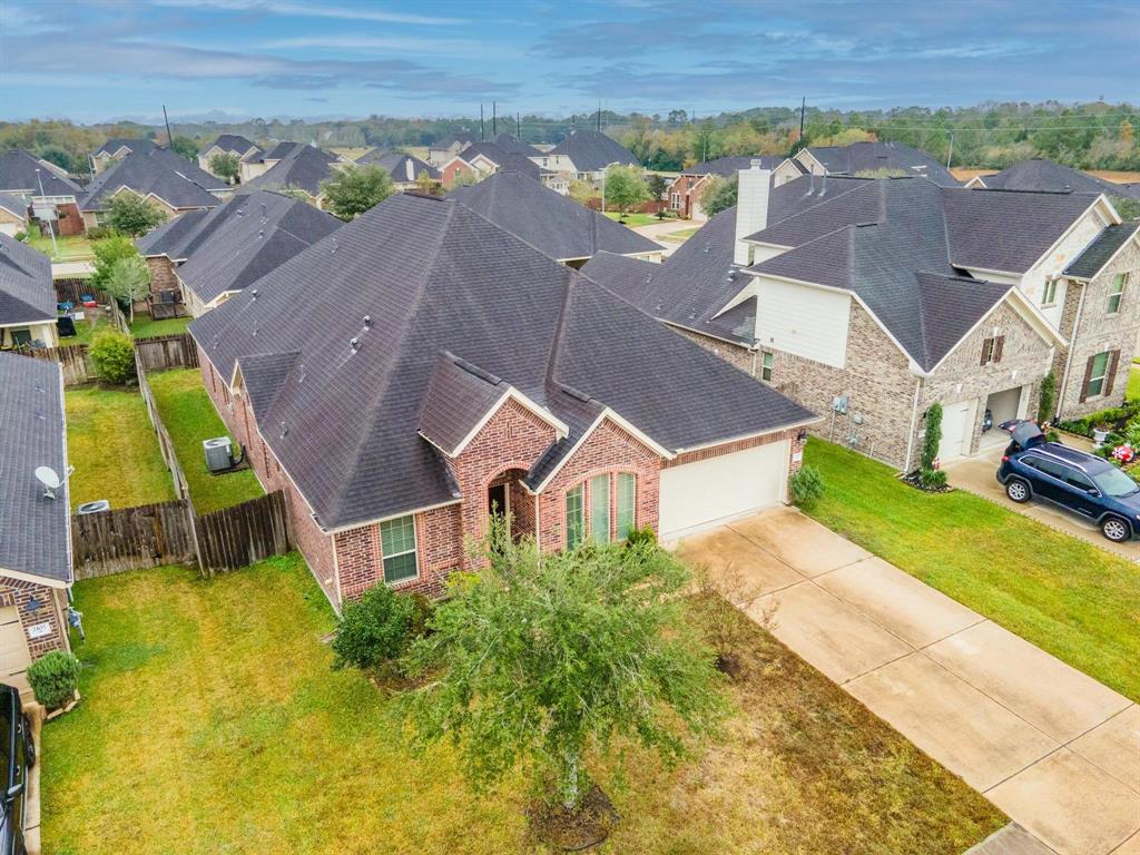 an aerial view of houses with a swimming pool