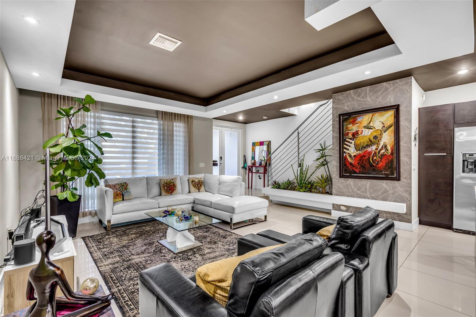 a living room with furniture and a potted plant