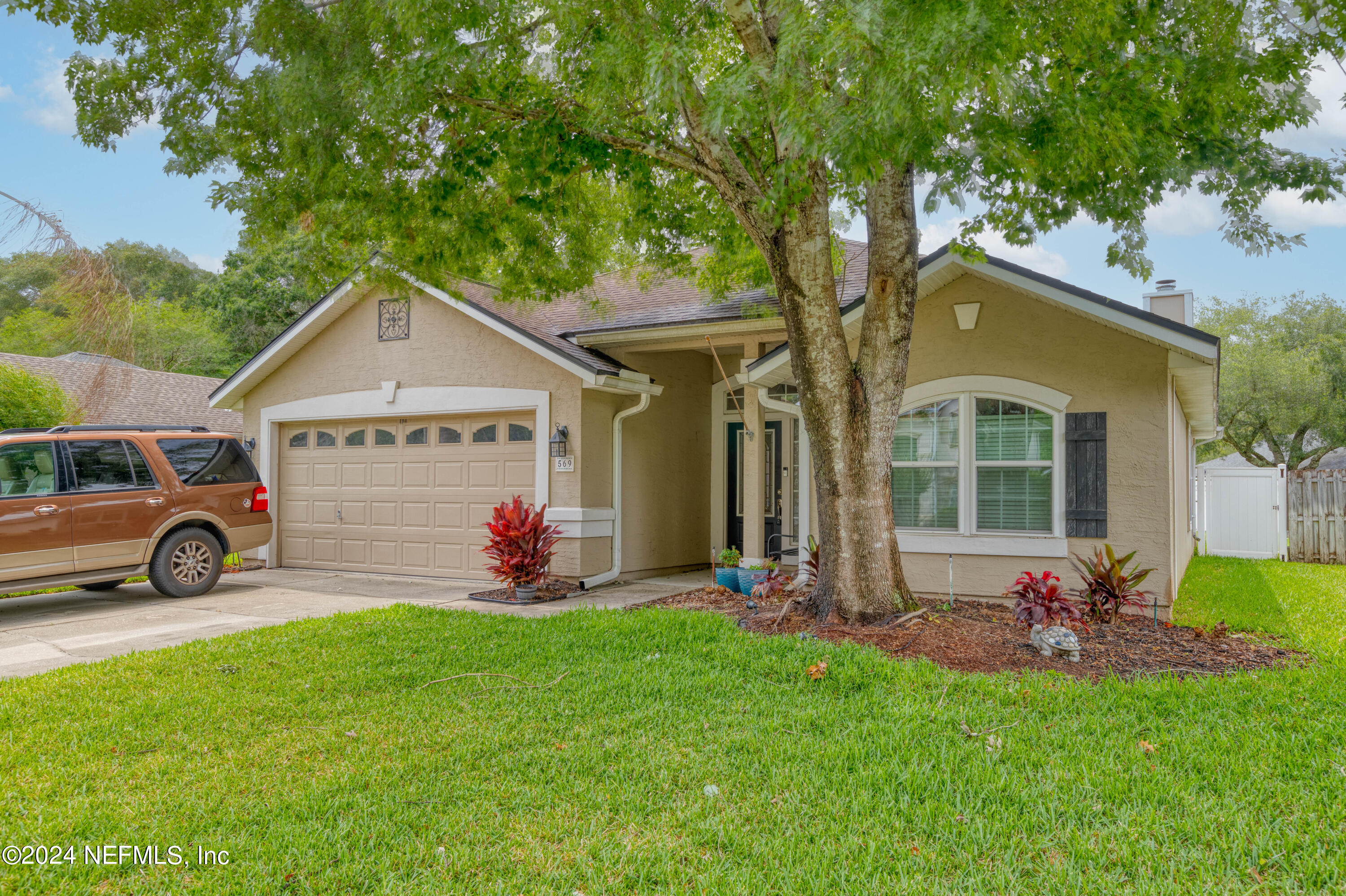 a front view of a house with swing and garage