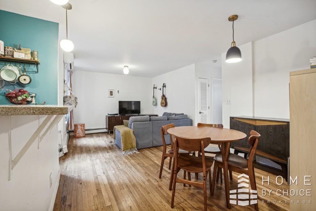 a view of a dining room with furniture and wooden floor