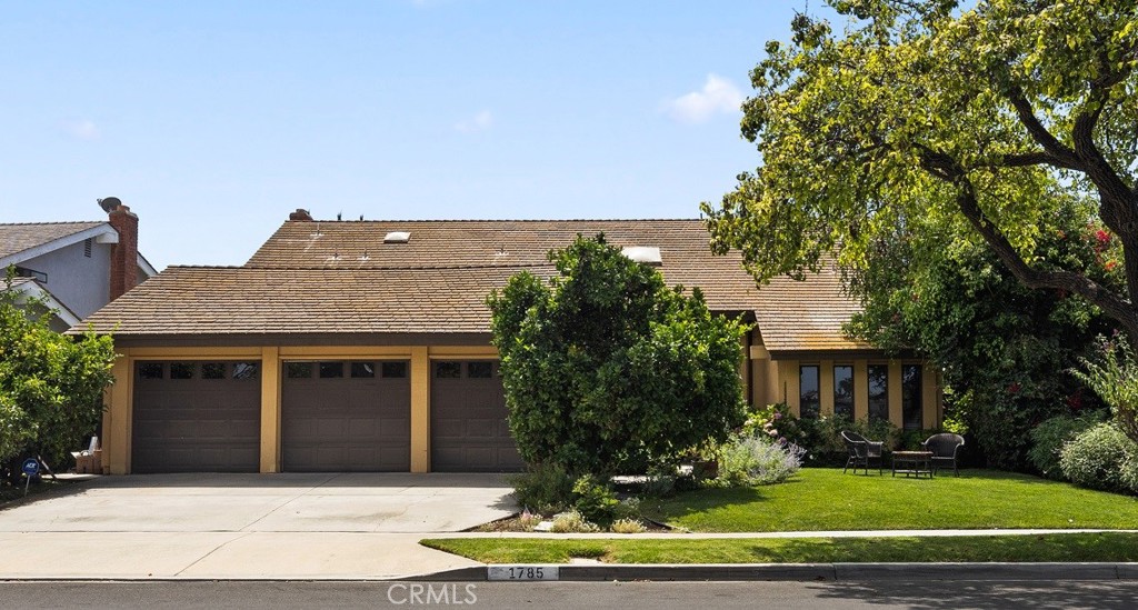 a front view of a house with a garden