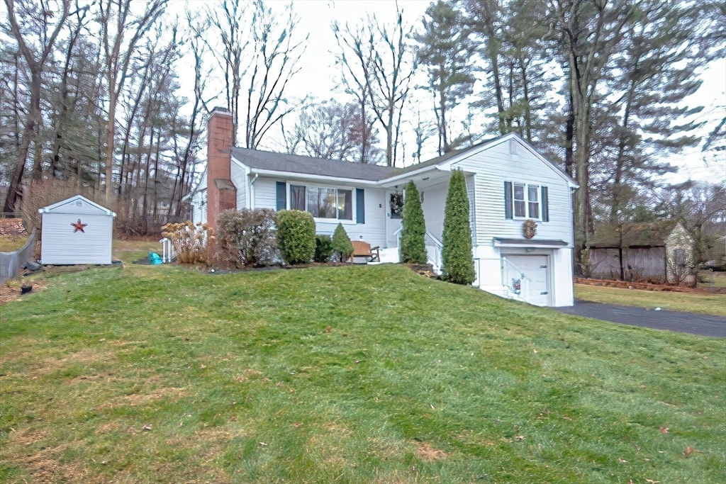 a front view of a house with a garden and plants