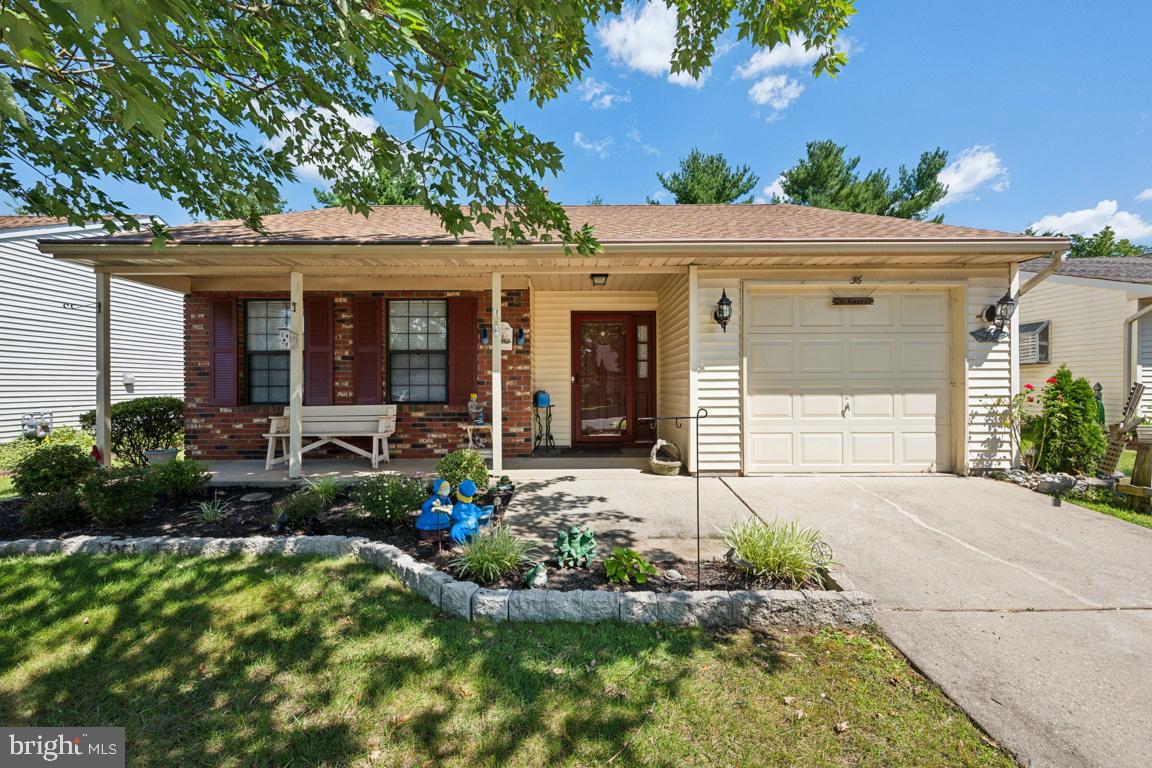 a front view of a house with a yard and potted plants