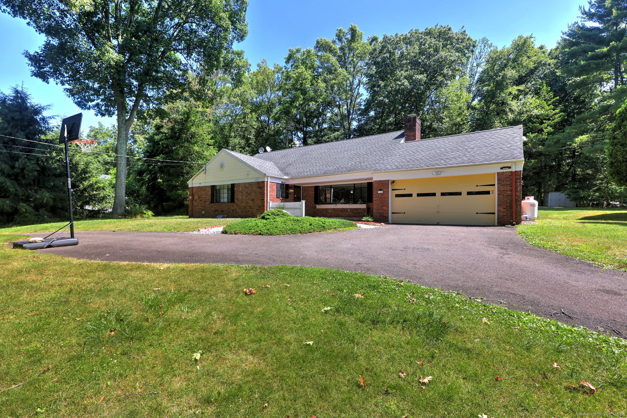 a front view of a house with yard and green space