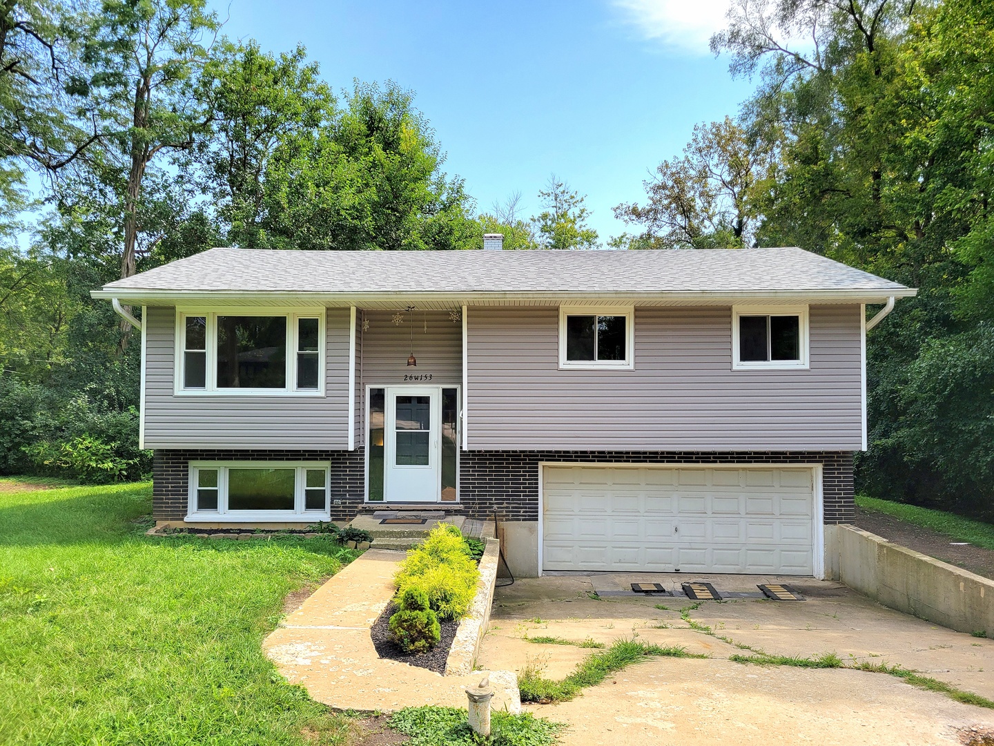 a front view of a house with a yard and garage