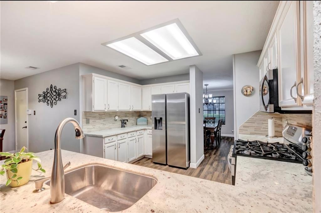 Just look at the abundant cabinets in this kitchen—offering all the storage space you could ever dream of!