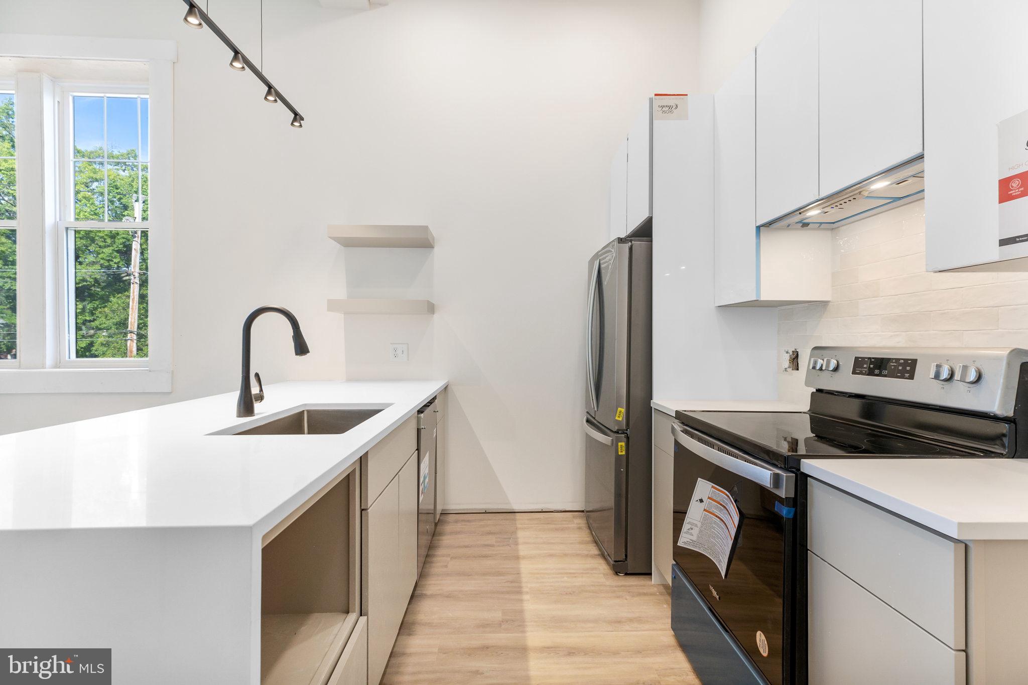 a kitchen with a sink and a refrigerator